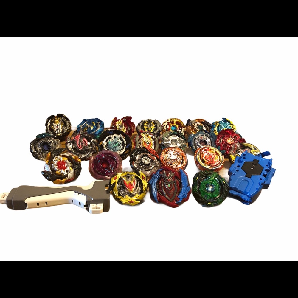 Lot of 23 used Beyblades with launcher and gripper